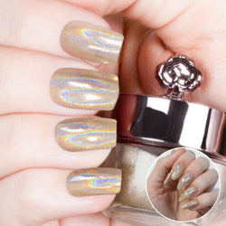 Nails featuring a champagne-gold holographic powder with warm burnt orange and brown undertones.

